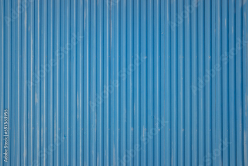 Detail of the texture of a blue-painted metal doorway