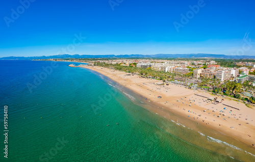 Beach, blue sea and palm trees in Salou city, Catalonia, Spain, Europe © oleg_p_100