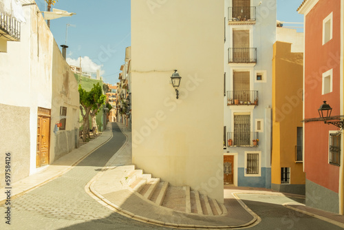 View to beautiful Villajoyosa street with multi-colored houses. Villajoyosa - coastal town in Alicante Province, Valencian Community, Spain, by Mediterranean Sea photo