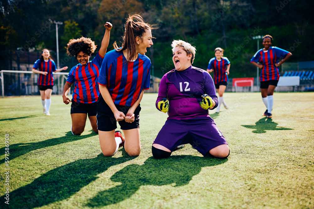 Obraz premium Soccer goalie and her teammates shout out of joy after winning match.