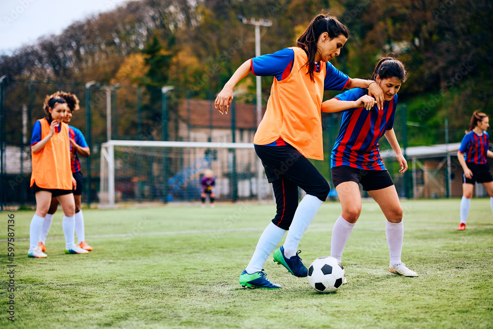 Female soccer players having sports training on playing field. Female soccer players having sports training on playing field.