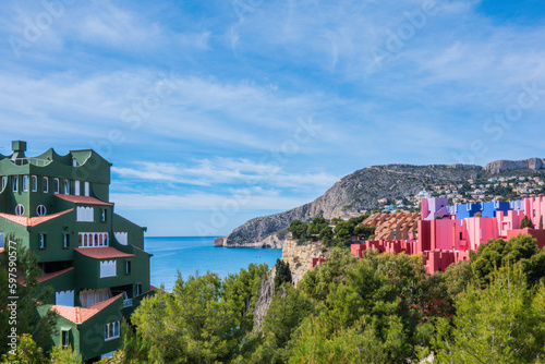 Panoramic view to Calpe with mountains and modern building La Muralla Roja red walls. Calp, Alicante province, Valencian Community, Spain photo