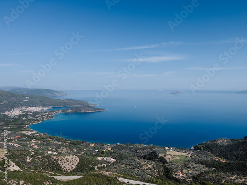 Blue sea at the foot of the mountain range merges with the horizon