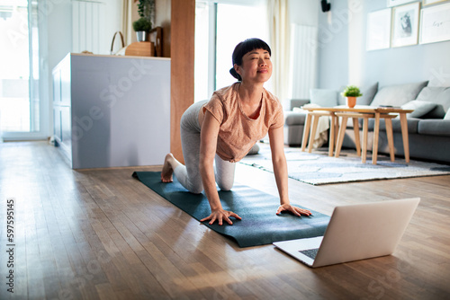Young Japanese woman doing yoga at home