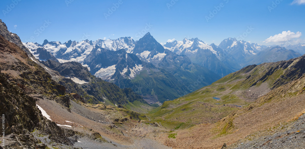 mountain valley with small lake under blue cloudy sky mountain valley with small lake under blue cloudy sky