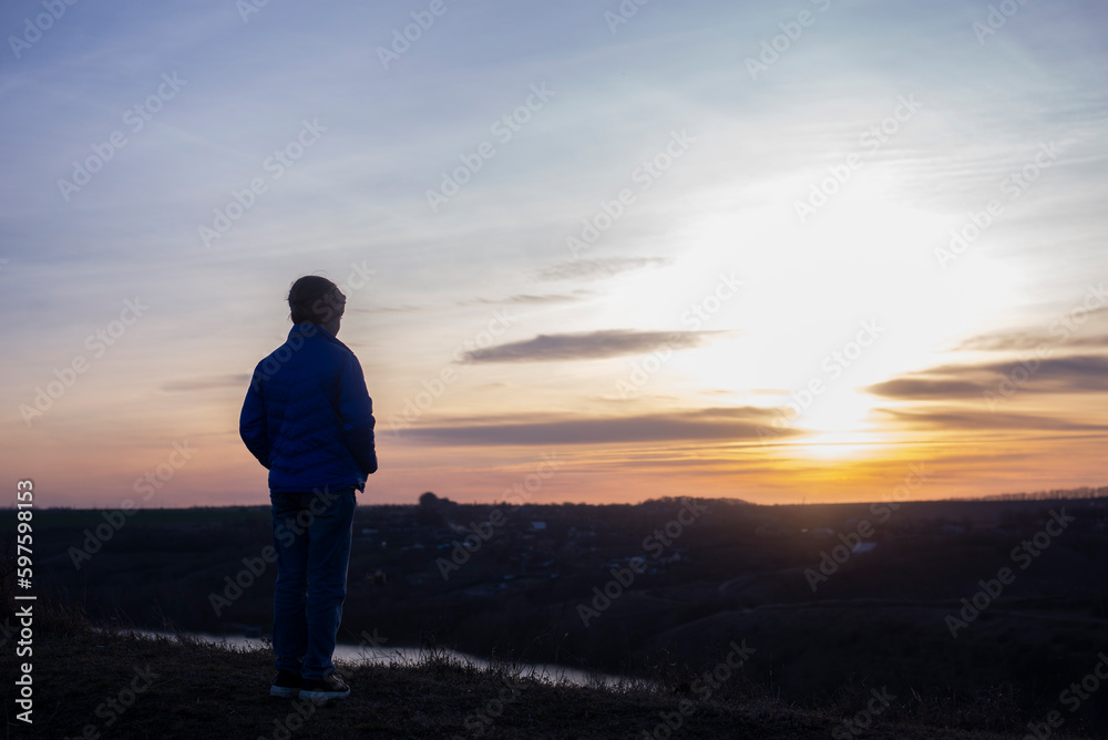 The girl on the background of the sky. Sunset evening morning. Loneliness and depression. Suma is a woman. pray The girl on the background of the sky. Sunset evening morning. Loneliness and depression. Suma is a woman. pray