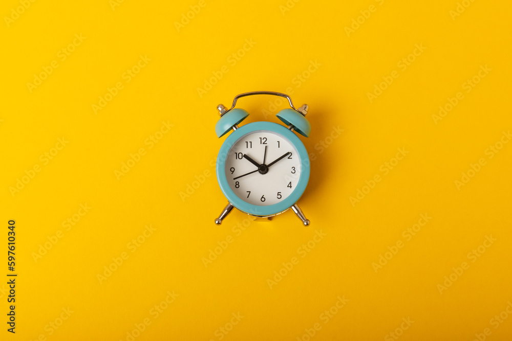 alarm clock on a bright yellow background.Top view.Close-up.Copy space. alarm clock on a bright yellow background.Top view.Close-up.Copy space.