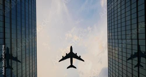 Airplane Flies Over Office Skyscrapers Against A Beautiful Blue Clouds
