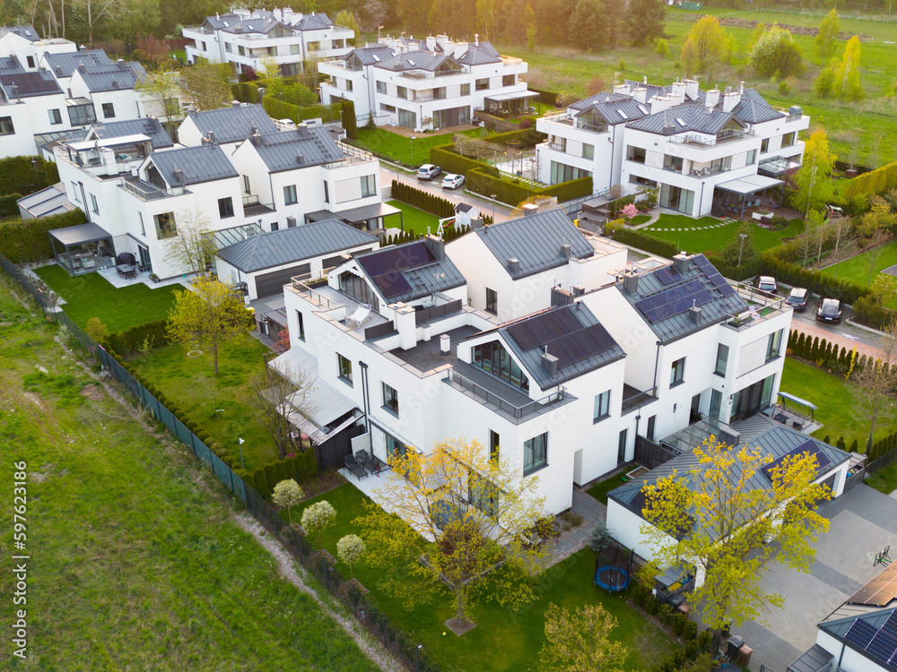 White modern houses with grey roofs in green scenery seen from above - obrazy, fototapety, plakaty 