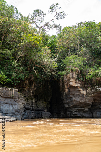 Rocks, amazonian river, boats and jungle in the area of colombian amazon