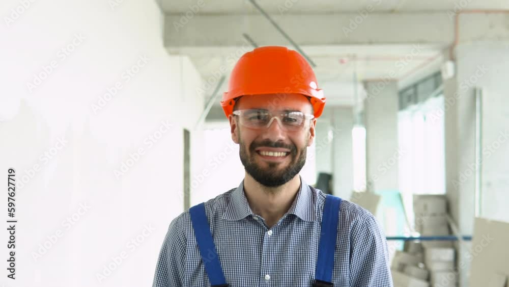 Portrait of funny builder on the construction site of modern office centre Portrait of funny builder on the construction site of modern office centre