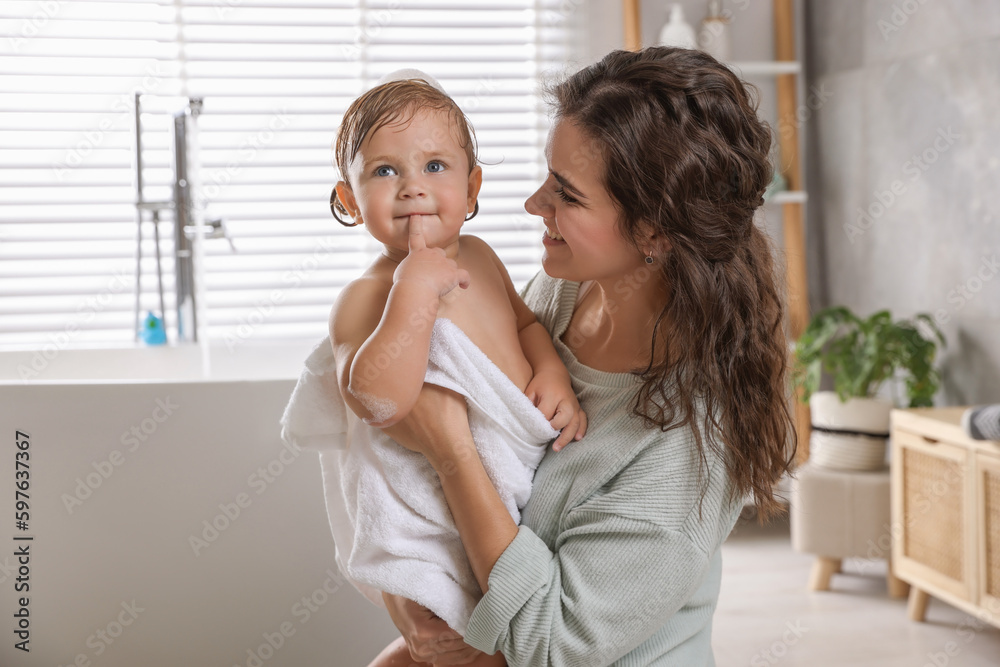Mother with her little daughter in bathroom