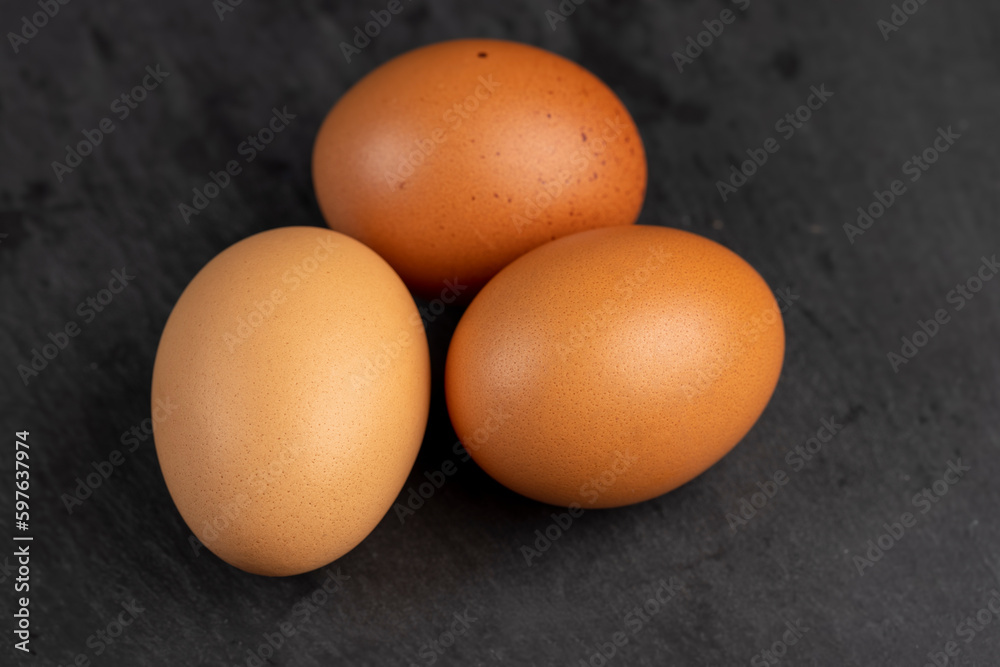 A whole orange chicken egg close-up on the table