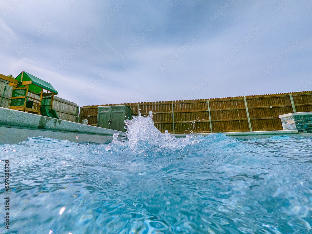 A serene photo capturing the perfect summer day with a vibrant swimming pool as the main focus, charmingly accompanied by a delightful duck enjoying a cool swim. A must-see for all nature and aquatic
