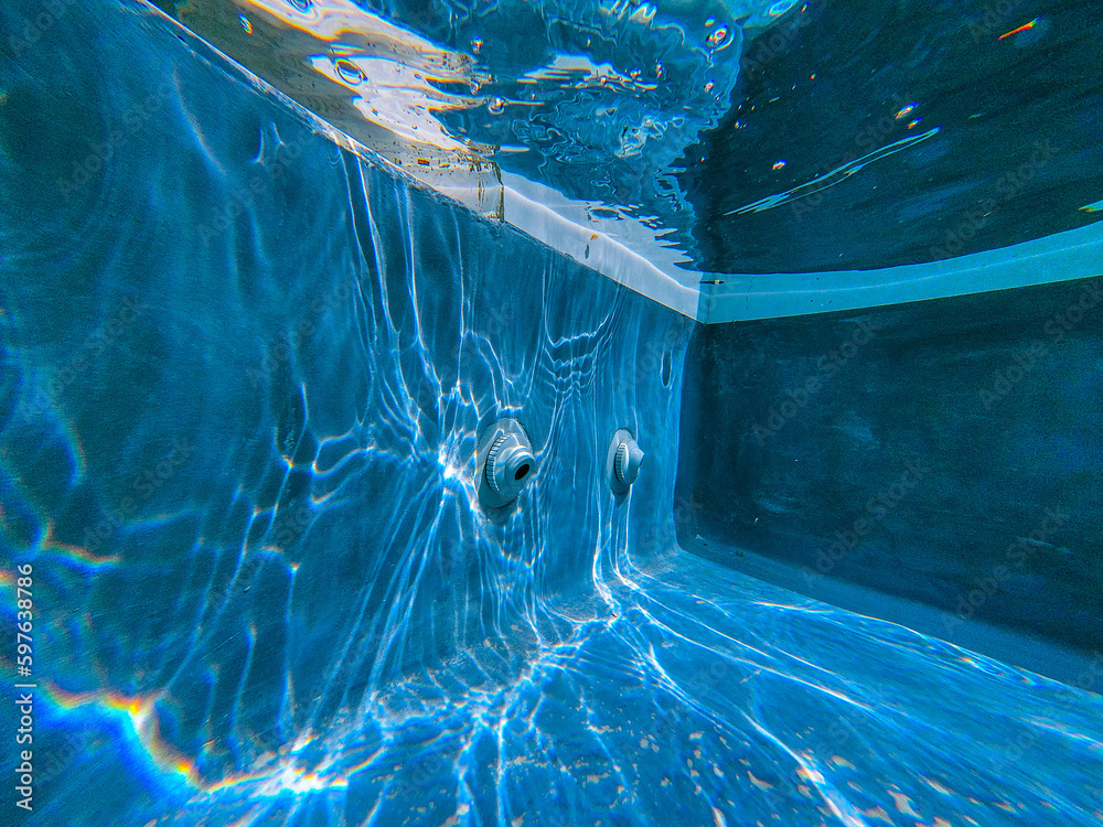 A serene photo capturing the perfect summer day with a vibrant swimming pool as the main focus, charmingly accompanied by a delightful duck enjoying a cool swim. A must-see for all nature and aquatic