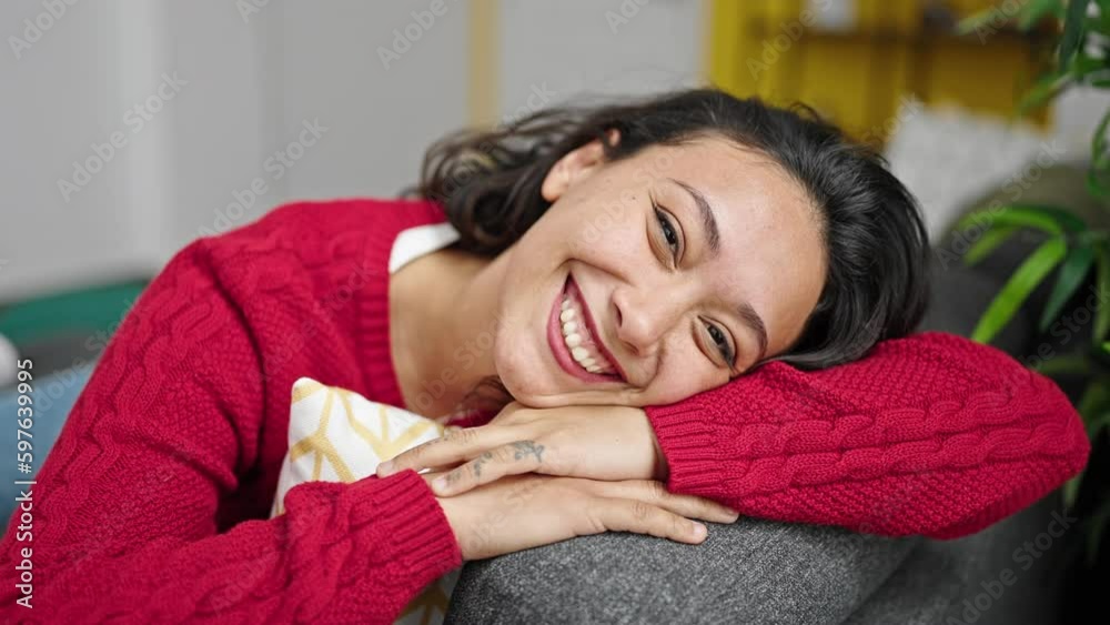 Young beautiful hispanic woman smiling confident sitting on sofa at home Young beautiful hispanic woman smiling confident sitting on sofa at home