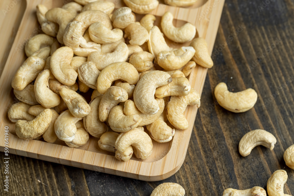 Hard roasted and peeled cashew nuts on the table Hard roasted and peeled cashew nuts on the table
