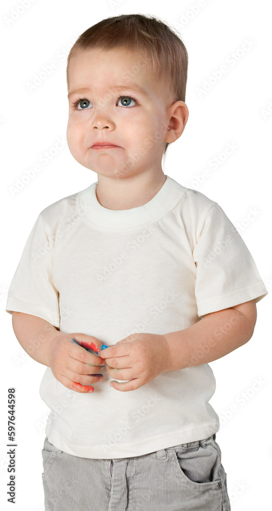 Young boy playing with his finger and looking sad
