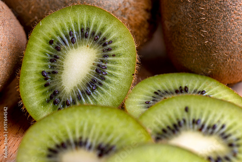 A group of cut green kiwi fruits with black seeds