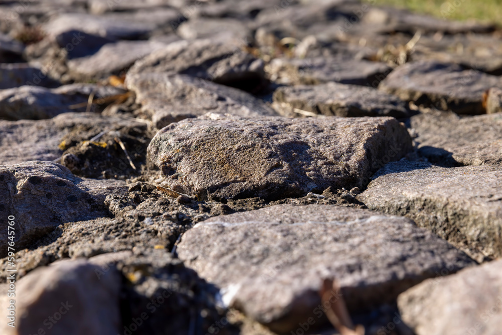 part of an old fence made of a large number of stones part of an old fence made of a large number of stones