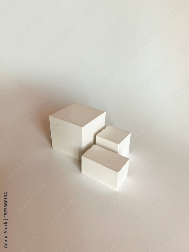 Fototapeta premium Abstract minimal nature scene - empty stage with three white rectangle podiums on white background. Pedestal for cosmetic product and packaging mockups display presentation