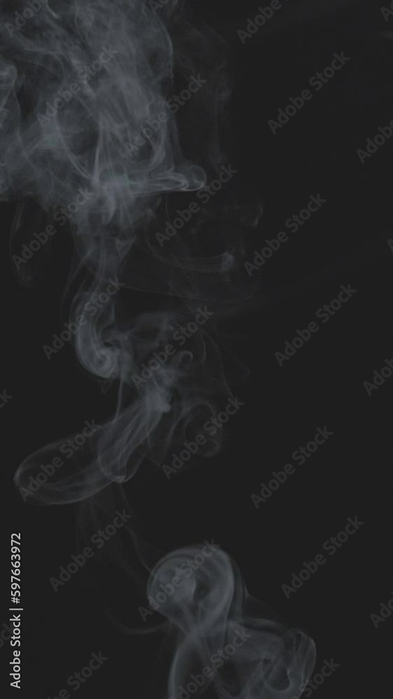 Slow motion vertical video of white smoke, fog, mist, vapor on a black background. Slow motion vertical video of white smoke, fog, mist, vapor on a black background.