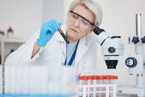 Medical science  blood test and analysis with scientist woman a vial for dna or medicine research. Expert person in laboratory with tube sample or study for healthcare  chemistry or investigation