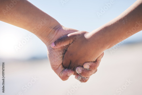 Love, unity and couple holding hands at a beach with trust, solidarity and commitment in nature. Hand, care and man with woman on romantic walk at the sea, sweet and bonding while traveling together
