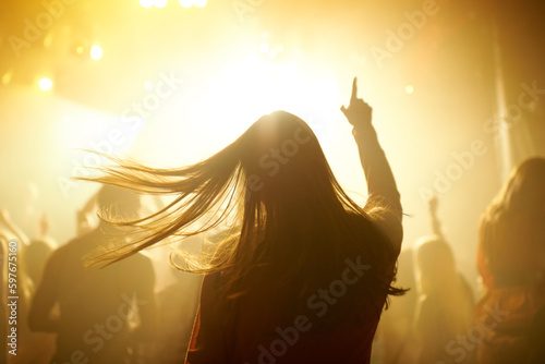 Photos Dance, music and back of woman at a concert, disco event or psychedelic trance festival