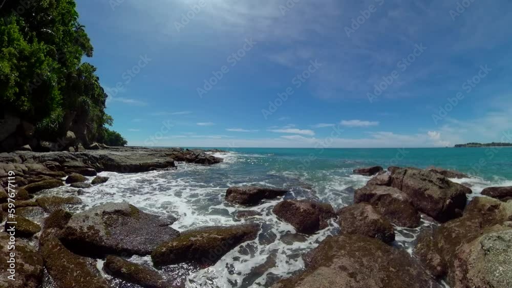 Rocky beach and ocean surf. Borneo, Malaysia. Kalampunian Beach.