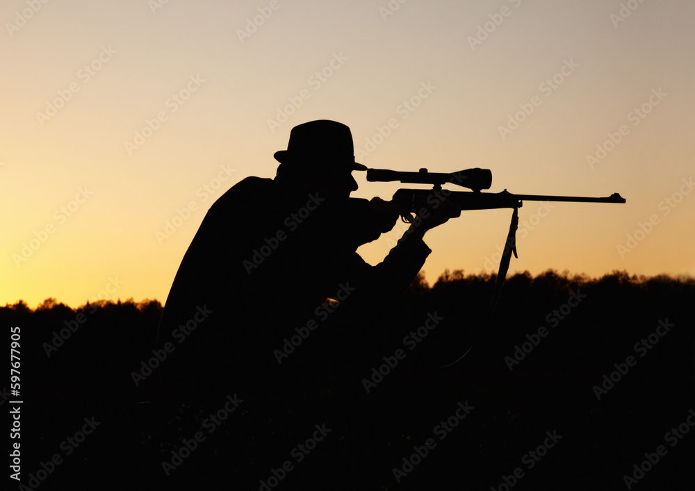 Hunting, sunset, man with gun and focus on target in nature to hunt game for sport on safari adventure. Sky, silhouette and hunter with rifle in bush, setting sun and shooting hobby on summer evening Hunting, sunset, man with gun and focus on target in nature to hunt game for sport on safari adventure. Sky, silhouette and hunter with rifle in bush, setting sun and shooting hobby on summer evening