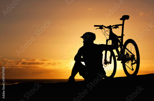Obraz na plátně Sunset, silhouette and bike with man at beach for relax, fitness and vacation trip