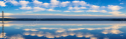 cloudscape. clouds in blue sky and reflection in large lake. White cumulus clouds in sky over blue sea water. , sunny summer day seascape panoramic. Generative AI © Celt Studio