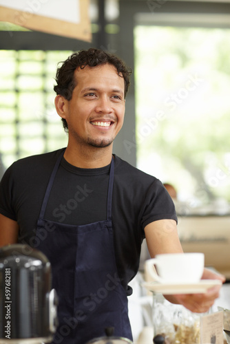 Coffee shop, barista and a man serving cup as small business, restaurant or startup owner. Smile of a happy entrepreneur man working as a waiter or manager with a drink or tea in a cafeteria or cafe