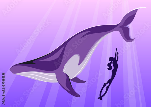 A freediver woman and a whale in the deep.
