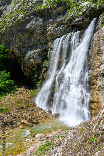 Fototapeta Naklejka Na Ścianę i Meble -  The waterfall in the tropical mountains. The alpine mountains and meadows.