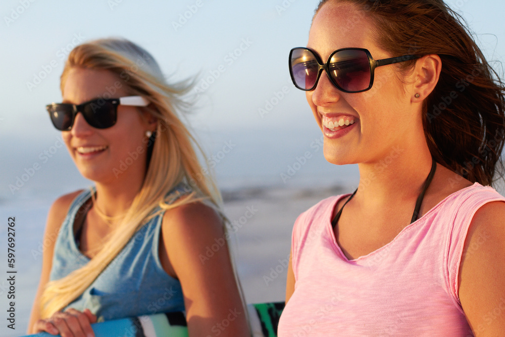 Summer, beach and woman friends surfing outdoor in nature together while on tropical holiday or vacation. Smile, sunglasses and a happy young female surfer with her friend on the coast to surf Summer, beach and woman friends surfing outdoor in nature together while on tropical holiday or vacation. Smile, sunglasses and a happy young female surfer with her friend on the coast to surf
