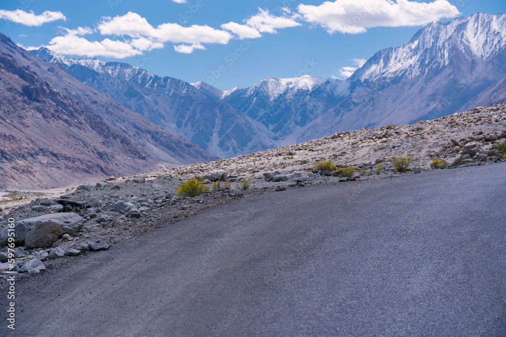road with two sides are high mountains, and blue sky. Beautiful scenery on the way to pangong lake, Leh, Ladakh, Jammu and Kashmir, India road with two sides are high mountains, and blue sky. Beautiful scenery on the way to pangong lake, Leh, Ladakh, Jammu and Kashmir, India