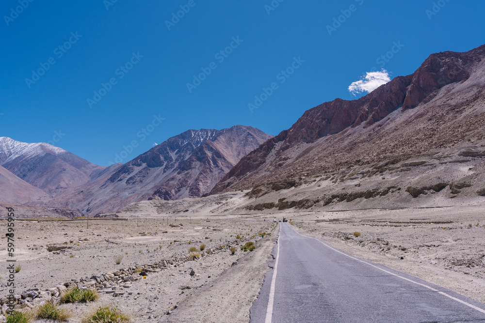 road with two sides are high mountains, and blue sky. Beautiful scenery on the way to pangong lake, Leh, Ladakh, Jammu and Kashmir, India road with two sides are high mountains, and blue sky. Beautiful scenery on the way to pangong lake, Leh, Ladakh, Jammu and Kashmir, India