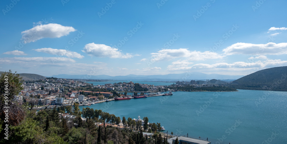 Greece, Chalkida city at Evia. Close up view of port from castle, building, cloudy sky background.