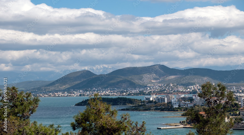 Greece, view of seafront Chalkida city from Karababa castle, Euripus Strait, cloudy sky background.