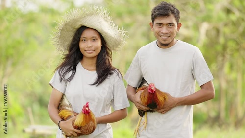 Portrait of asian Farmers with cockfighting Roosters, on Farm in Countryside photo