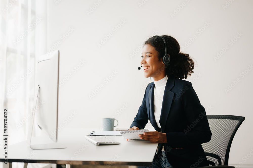 Serious call center operator in wireless headset talking with customer, woman in headphones with microphone consulting client on phone in customer support service in business center Serious call center operator in wireless headset talking with customer, woman in headphones with microphone consulting client on phone in customer support service in business center