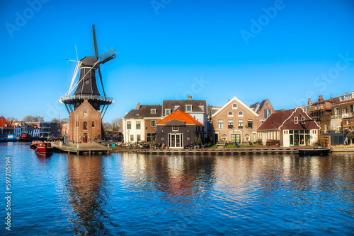The Binnen Spaarne Canal Running through Haarlem, the Netherlands, with the Famous Windmill De Adriaan