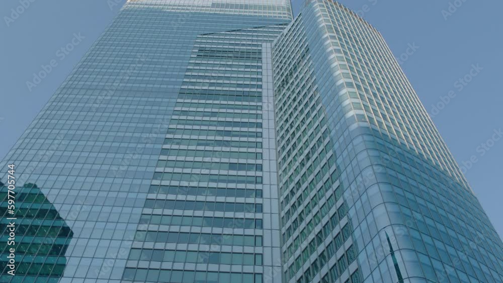 Office building windows and bottom view of skyscraper building with many corporate offices of successful companies. Real estate rental and commercial use. Office building windows and bottom view of skyscraper building with many corporate offices of successful companies. Real estate rental and commercial use.