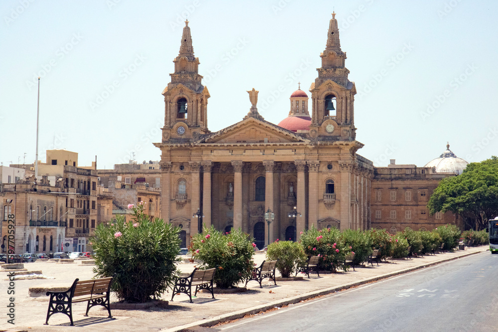 Saint Publius Parish Church with town square at City of 	Floriana on a sunny summer day. Photo taken August 9th, 2017, Valletta, Malta.