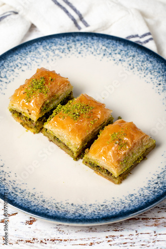 Pistachio baklava on wood background. Traditional Turkish baklava with pistachio. Sherbet dessert. Close up