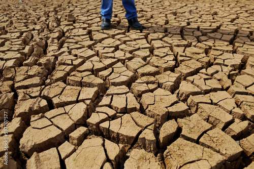 A man walks in a cracked ground of an empty water reservoir during a severe drought in Sao Paulo state, Brazil.