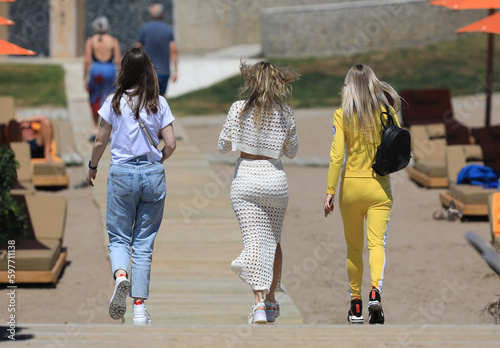three girls are walking in the resort