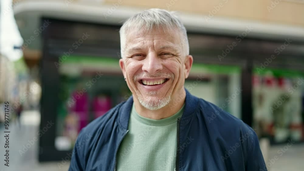 Middle age grey-haired man smiling confident standing at street Middle age grey-haired man smiling confident standing at street